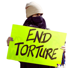 Protestor holding "End Torture" sign